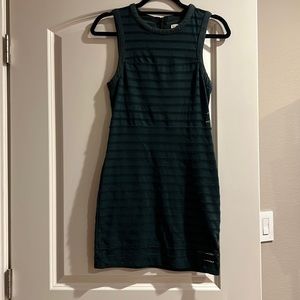 Dark green  stretchy mini dress with zipper in back. Size Medium.